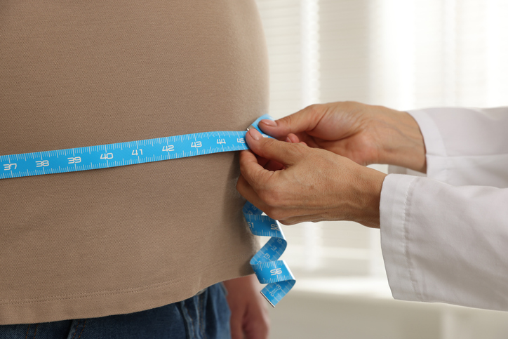 doctor measuring patients weight